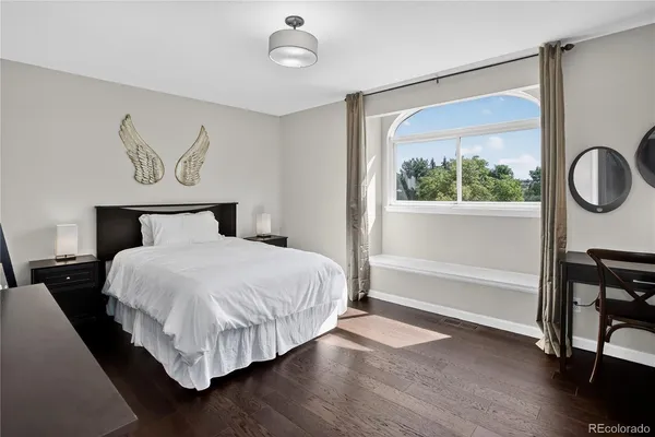 a bedroom with a bed next to a window with the outer view