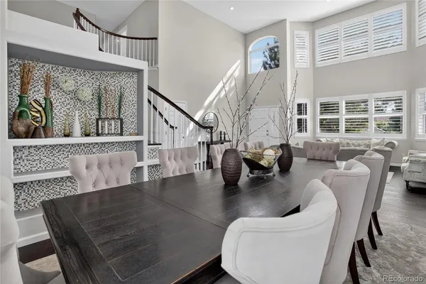 a living room with furniture floor to ceiling window and potted plant