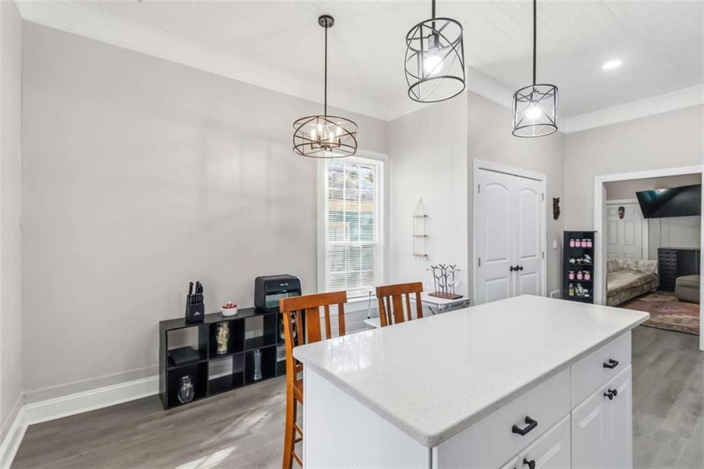 949 East Solomon Street Griffin, GA 30223 - Photo 11 of 26 a very nice looking dining room with a table chairs and wooden floor