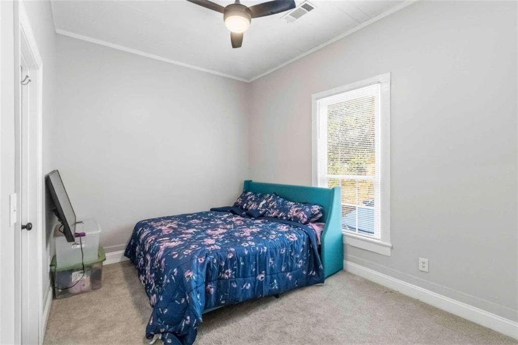 949 East Solomon Street Griffin, GA 30223 - Photo 14 of 26 a bed sitting in a bedroom next to a window