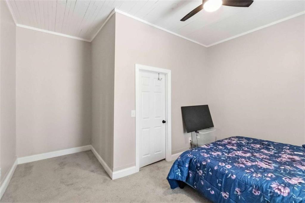 949 East Solomon Street Griffin, GA 30223 - Photo 15 of 26 a bedroom with a bed and a flat screen tv