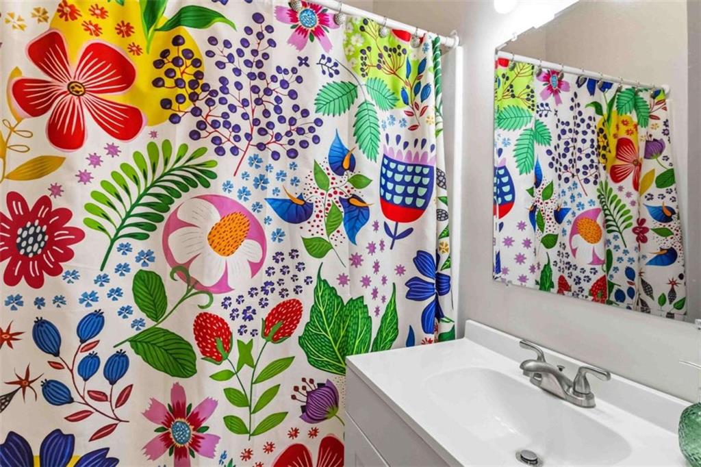 949 East Solomon Street Griffin, GA 30223 - Photo 17 of 26 a bathroom with a sink and a mirror