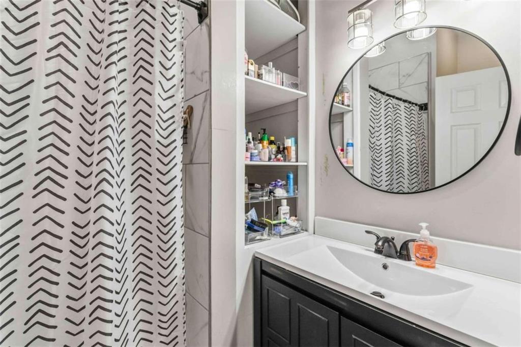 949 East Solomon Street Griffin, GA 30223 - Photo 20 of 26 a bathroom with a mirror and a sink