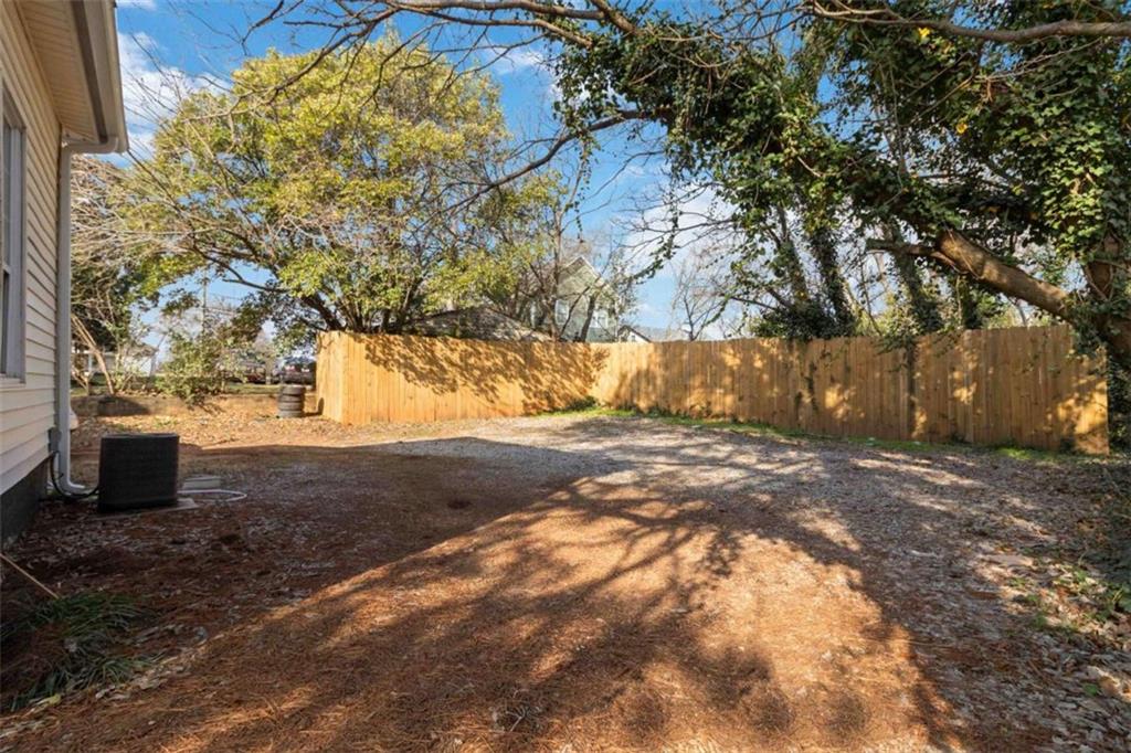 949 East Solomon Street Griffin, GA 30223 - Photo 25 of 26 a view of a yard with plants and trees