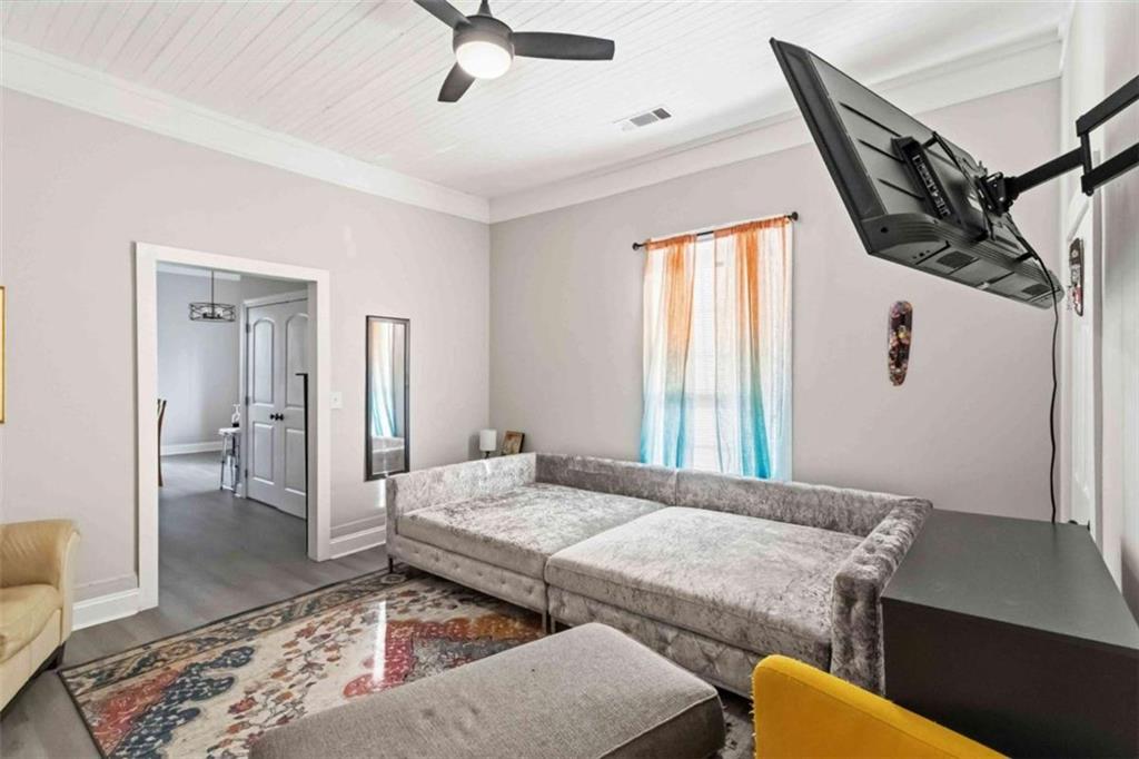 949 East Solomon Street Griffin, GA 30223 - Photo 6 of 26 a bedroom with a bed and wooden floor