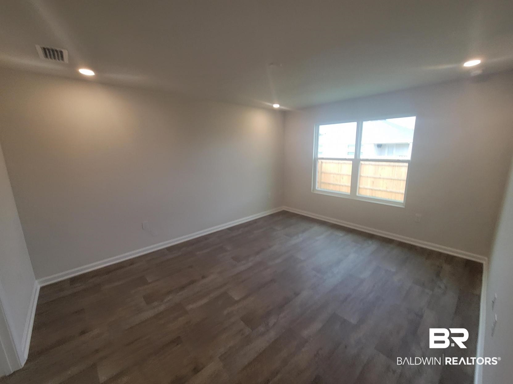 24625 Ponder Loop Loxley, AL 36551 - Photo 22 of 30 Unfurnished room featuring dark hardwood / wood-style flooring