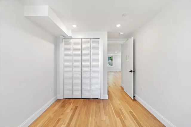 a view of a hallway with wooden floor