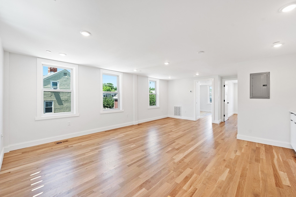 290 Washington Street, Unit 2 Marblehead, MA 01945 - Photo 17 of 25 a view of empty room with wooden floor and windows