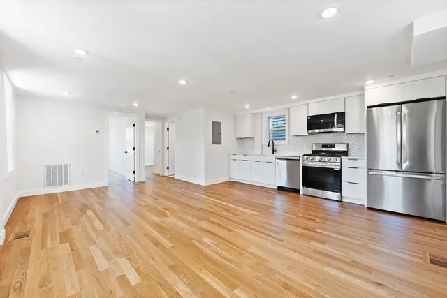 a kitchen with stainless steel appliances a refrigerator and a stove top oven