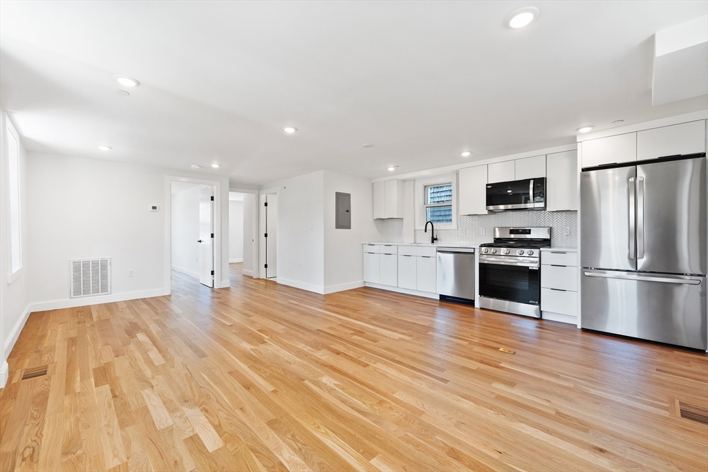 290 Washington Street, Unit 2 Marblehead, MA 01945 - Photo 7 of 25 a kitchen with stainless steel appliances a refrigerator and a stove top oven