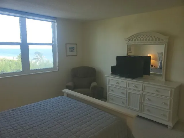 a bedroom with a bed and a television