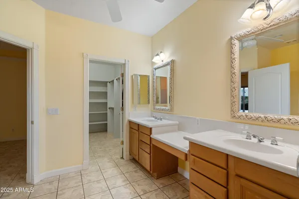 an empty room with a window and a ceiling fan