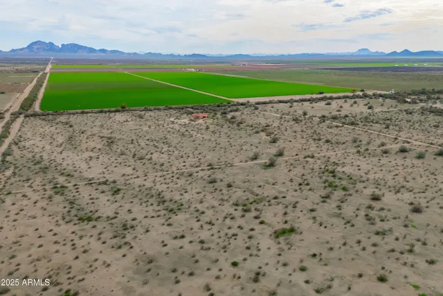 a front view of a house with a yard and a lake view