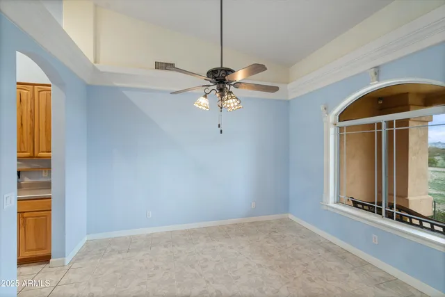 a kitchen with stainless steel appliances granite countertop a sink a stove cabinets dining table and chairs