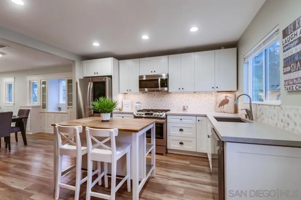 11461 Posthill Place Lakeside, CA 92040 - Photo 15 of 46 a kitchen with a sink stove and microwave