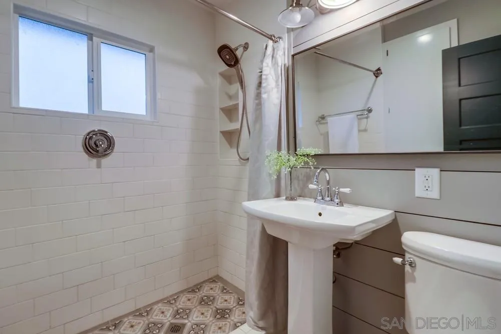 11461 Posthill Place Lakeside, CA 92040 - Photo 23 of 46 a bathroom with a sink a toilet a mirror and shower