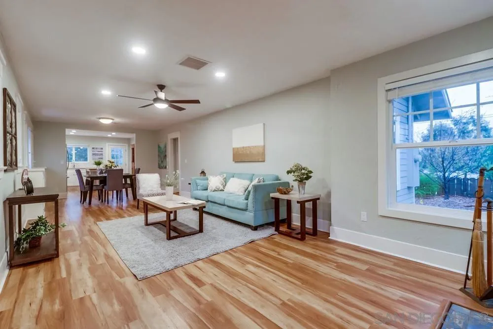 11461 Posthill Place Lakeside, CA 92040 - Photo 7 of 46 a living room with furniture a rug kitchen view and a large window