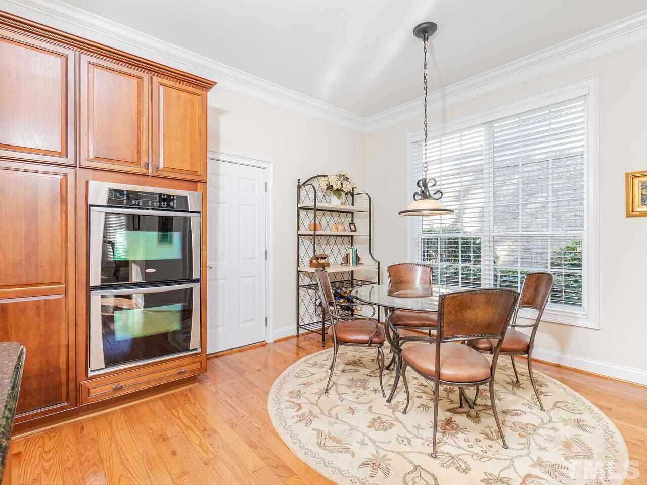 2267 Clayette Court Raleigh, NC 27612 - Photo 12 of 29 a view of a dining room with furniture window and wooden floor