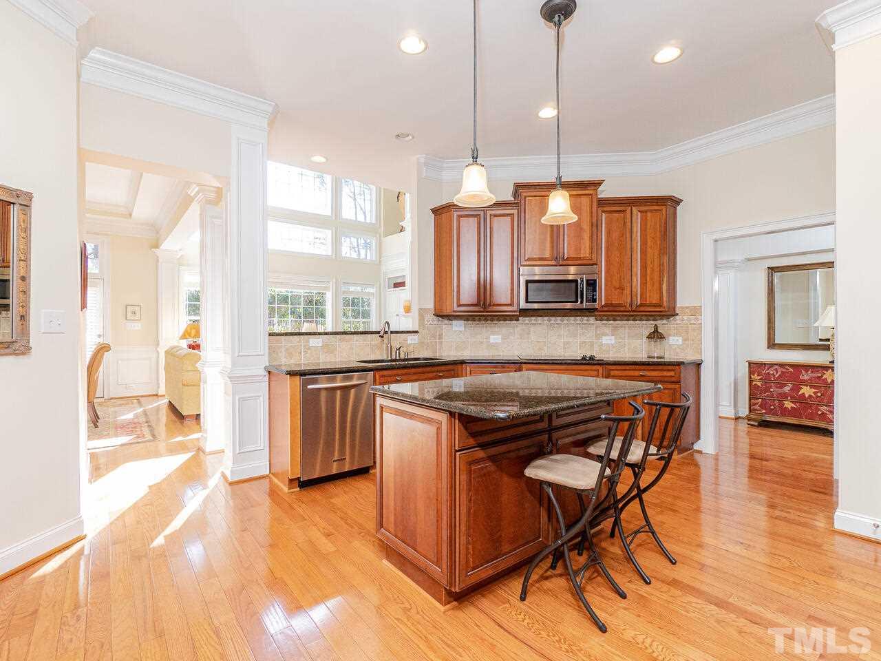 2267 Clayette Court Raleigh, NC 27612 - Photo 14 of 29 a kitchen with a table chairs sink and wooden floor
