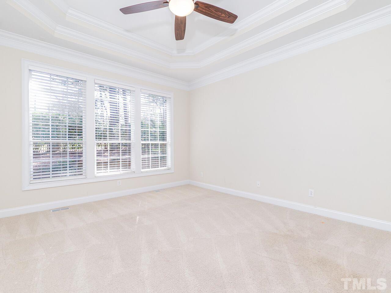 2267 Clayette Court Raleigh, NC 27612 - Photo 18 of 29 an empty room with a window and a ceiling fan