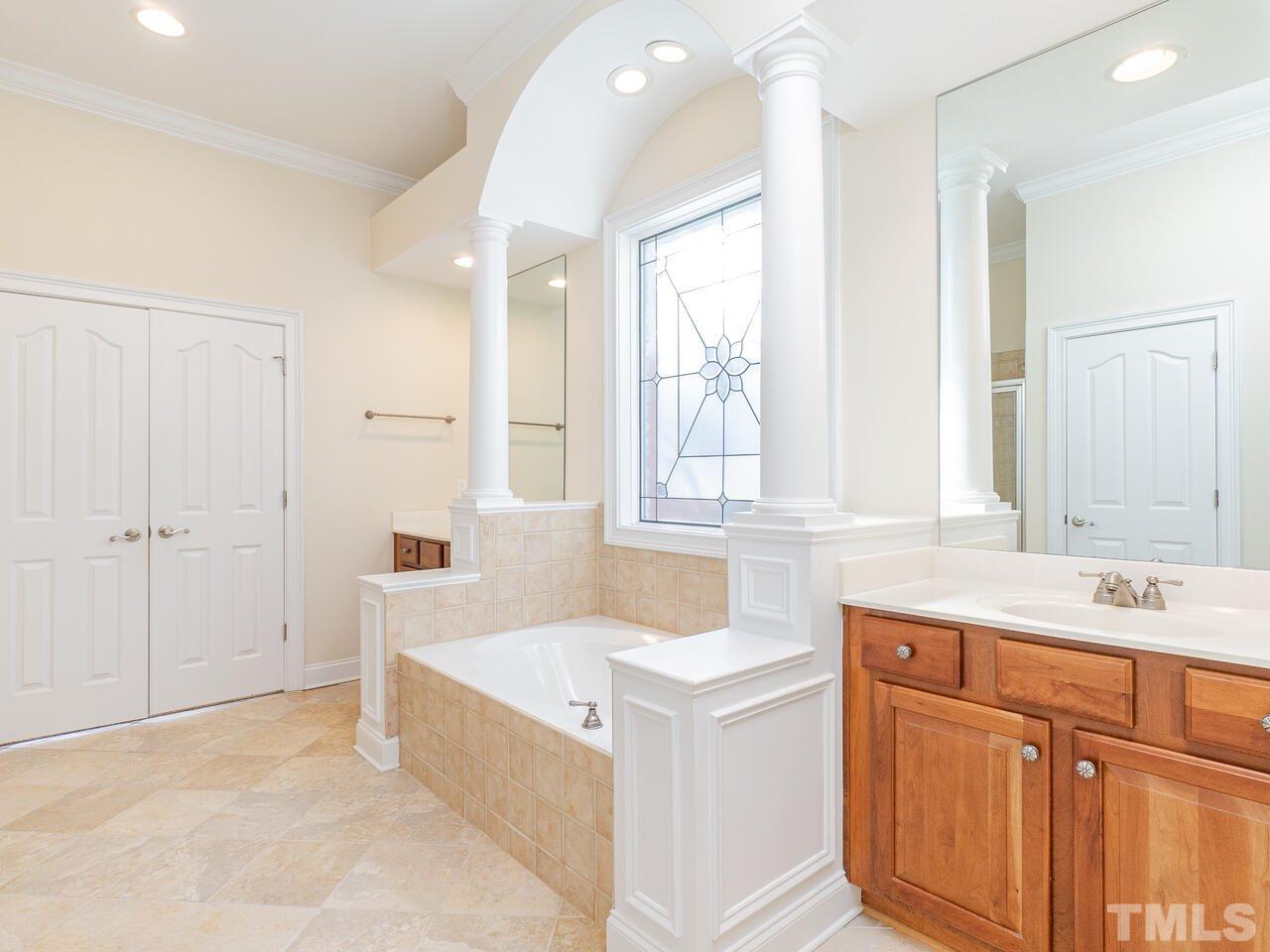 2267 Clayette Court Raleigh, NC 27612 - Photo 19 of 29 a bathroom with a tub sink and mirror