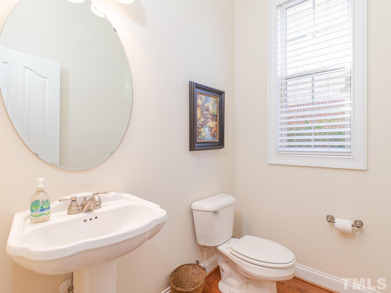 2267 Clayette Court Raleigh, NC 27612 - Photo 22 of 29 a bathroom with a sink a mirror and a toilet