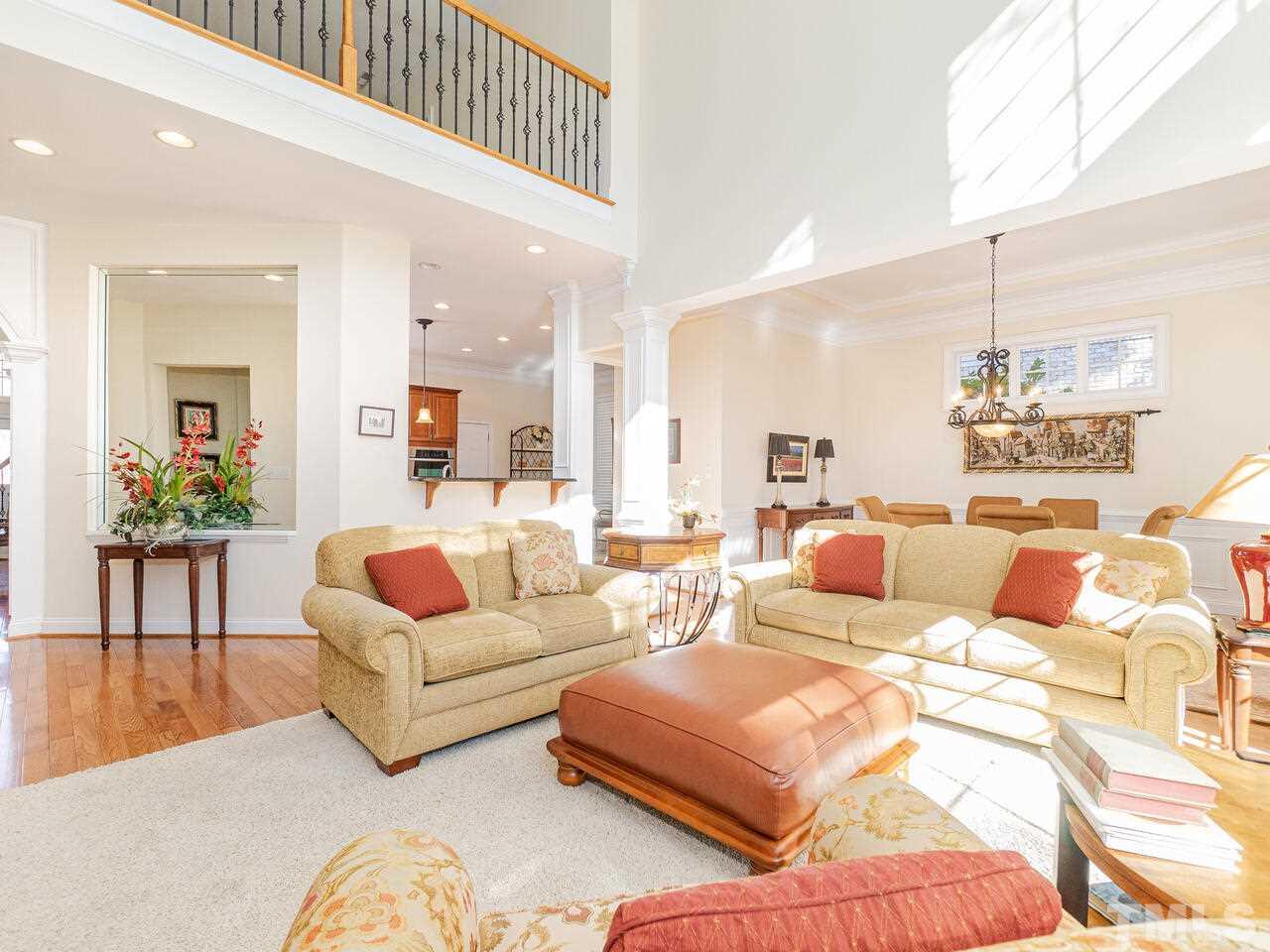 2267 Clayette Court Raleigh, NC 27612 - Photo 24 of 29 a living room with furniture and a chandelier
