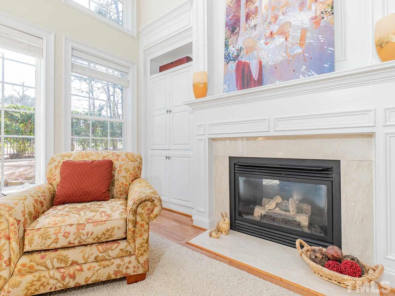 2267 Clayette Court Raleigh, NC 27612 - Photo 25 of 29 a living room with furniture a window and a fireplace