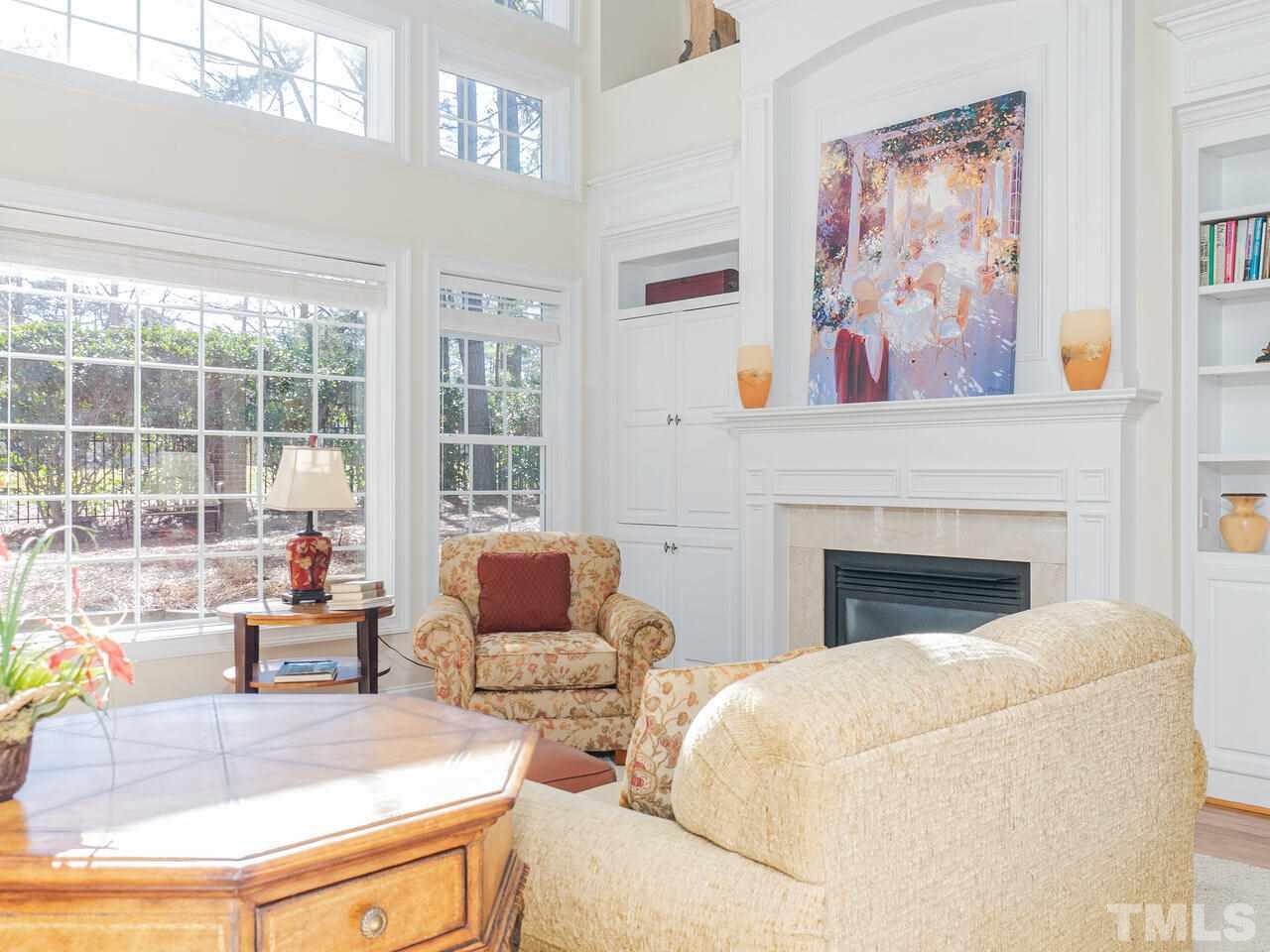 2267 Clayette Court Raleigh, NC 27612 - Photo 8 of 29 a living room with furniture a large window and a fireplace