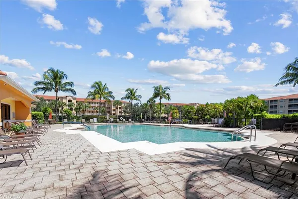 a view of a swimming pool with a patio and a garden