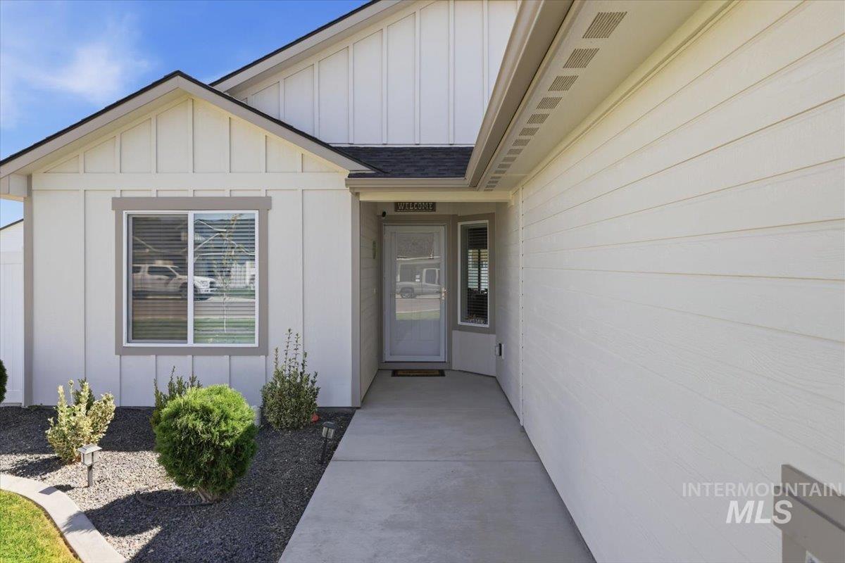 918 Sierra Street Vale, OR 97918 - Photo 6 of 42 Contemporary exterior with board and batten and horizontal siding accents, a paved walkway, and low-maintenance landscaping
