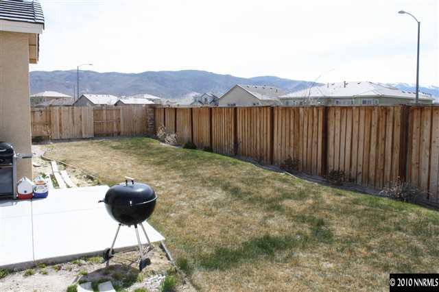 1640 Murrieta Court Reno, NV 89521 - Photo 8 of 9 a backyard of a house with table and chairs