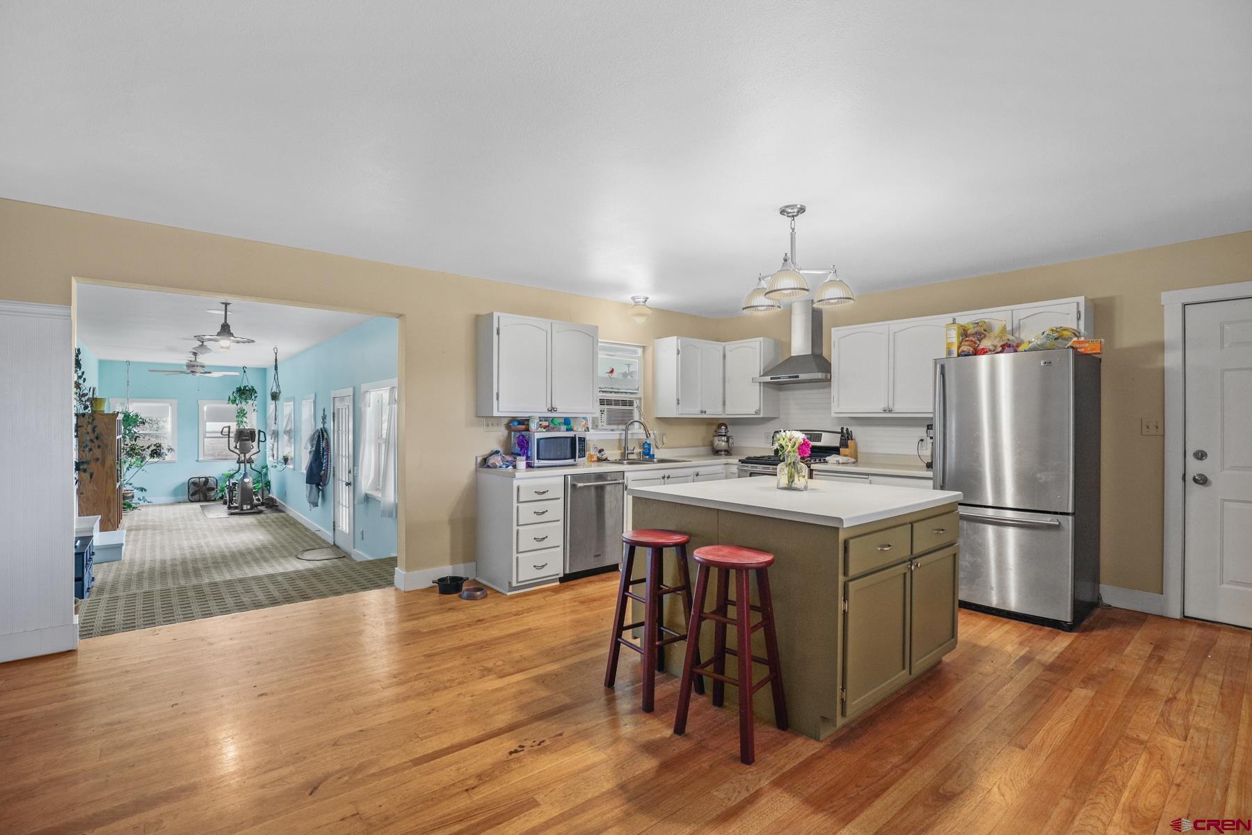 25548 Rd N 6 Loop Cortez, CO 81321 - Photo 15 of 35 a kitchen with a sink a refrigerator and chairs