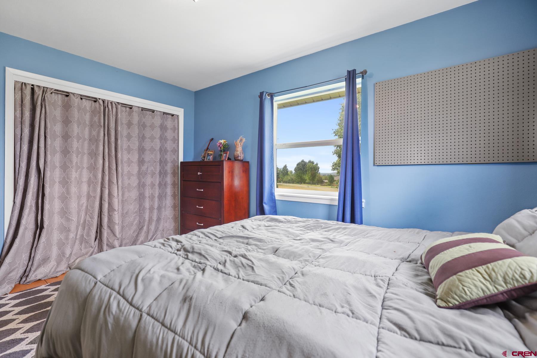 25548 Rd N 6 Loop Cortez, CO 81321 - Photo 27 of 35 a bedroom with a bed and a dresser