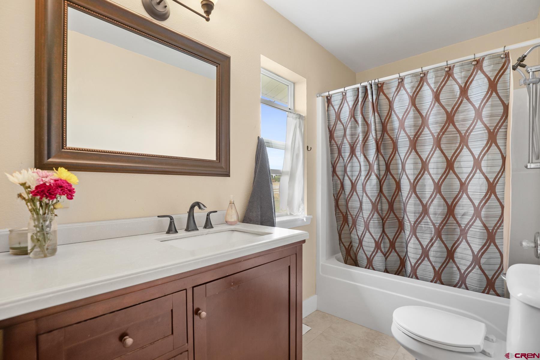 25548 Rd N 6 Loop Cortez, CO 81321 - Photo 30 of 35 a bathroom with a sink a toilet and a mirror