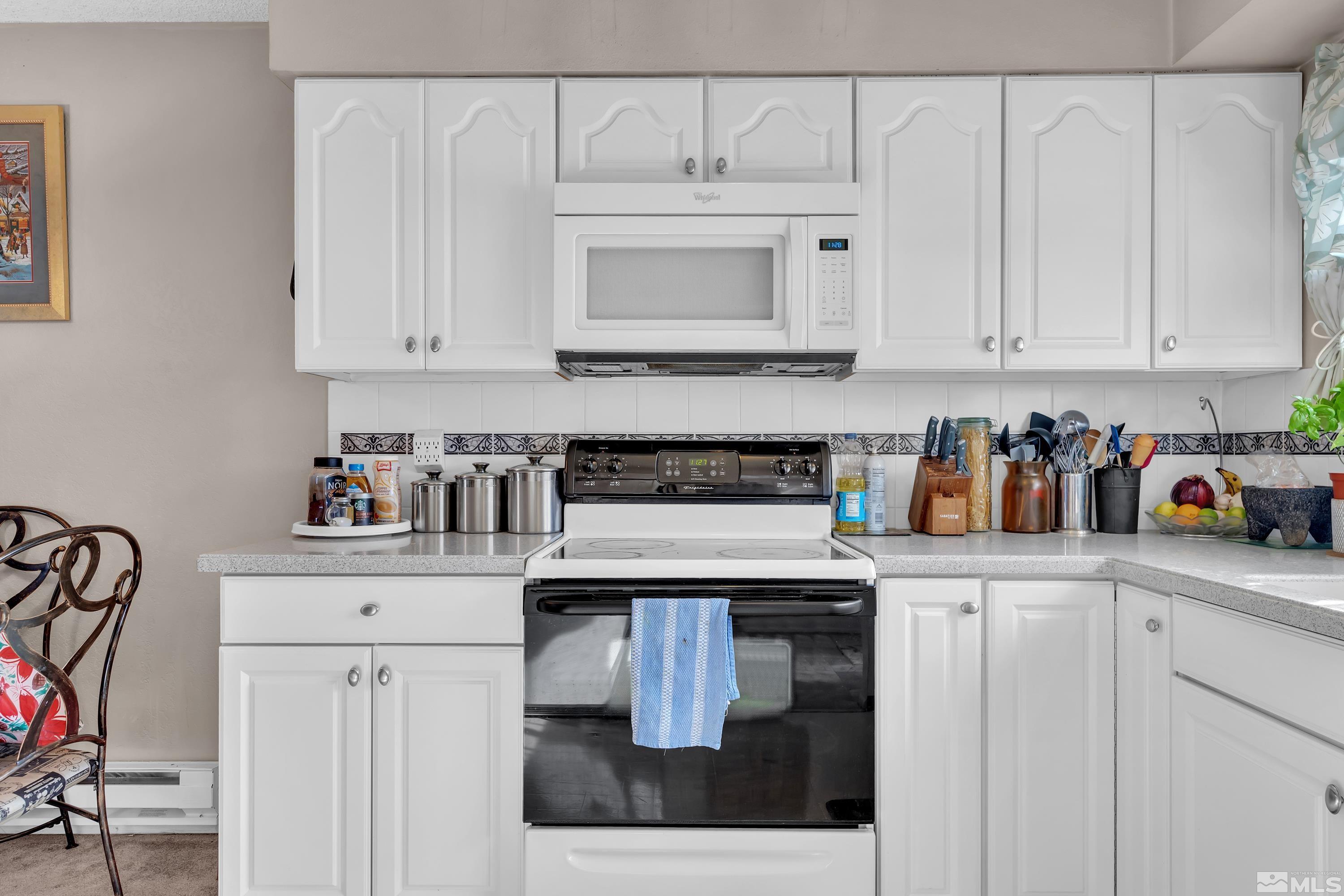 335 Smithridge Park Reno, NV 89502 - Photo 12 of 30 a kitchen with white cabinets and sink