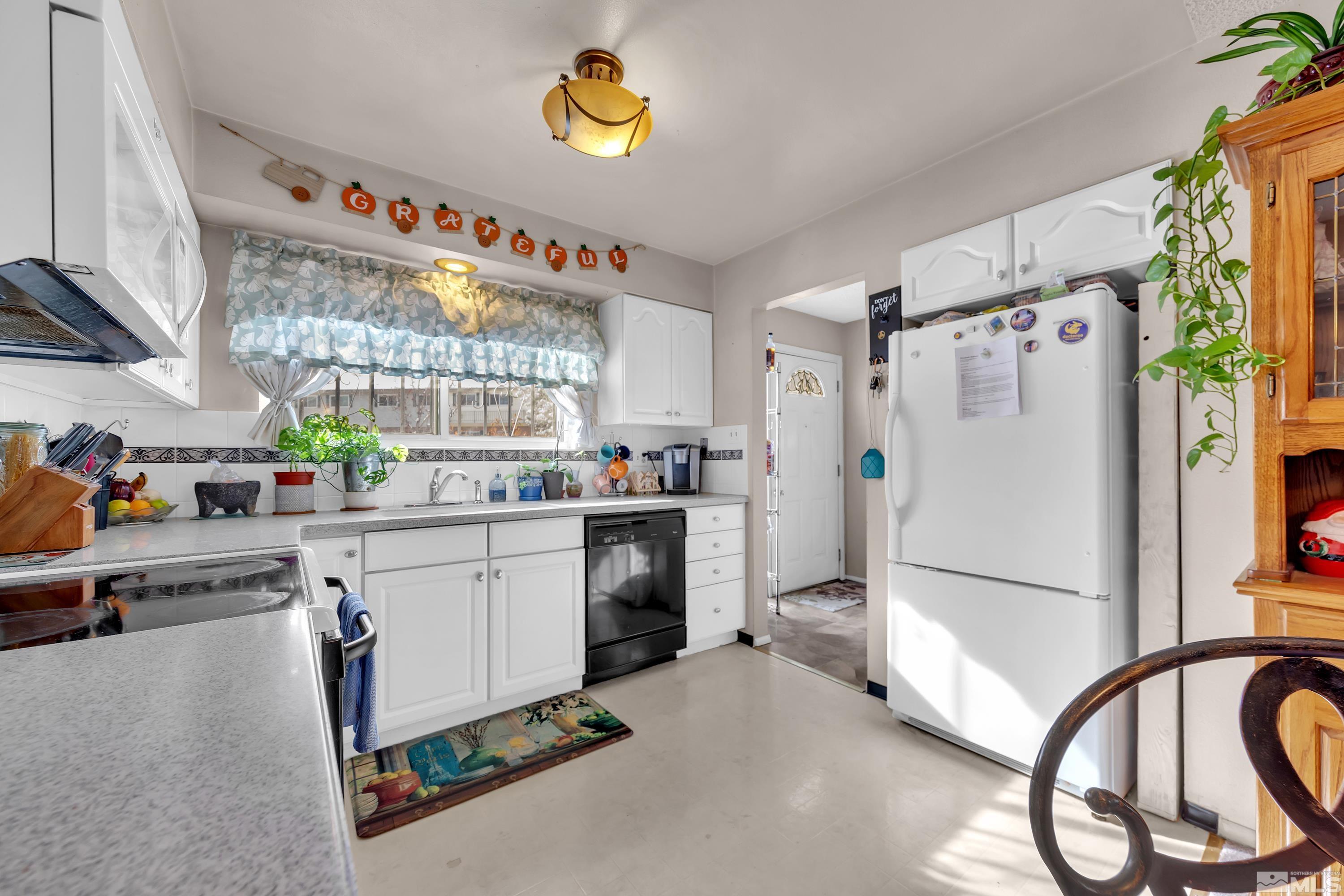 335 Smithridge Park Reno, NV 89502 - Photo 13 of 30 a kitchen with a refrigerator and a stove top oven