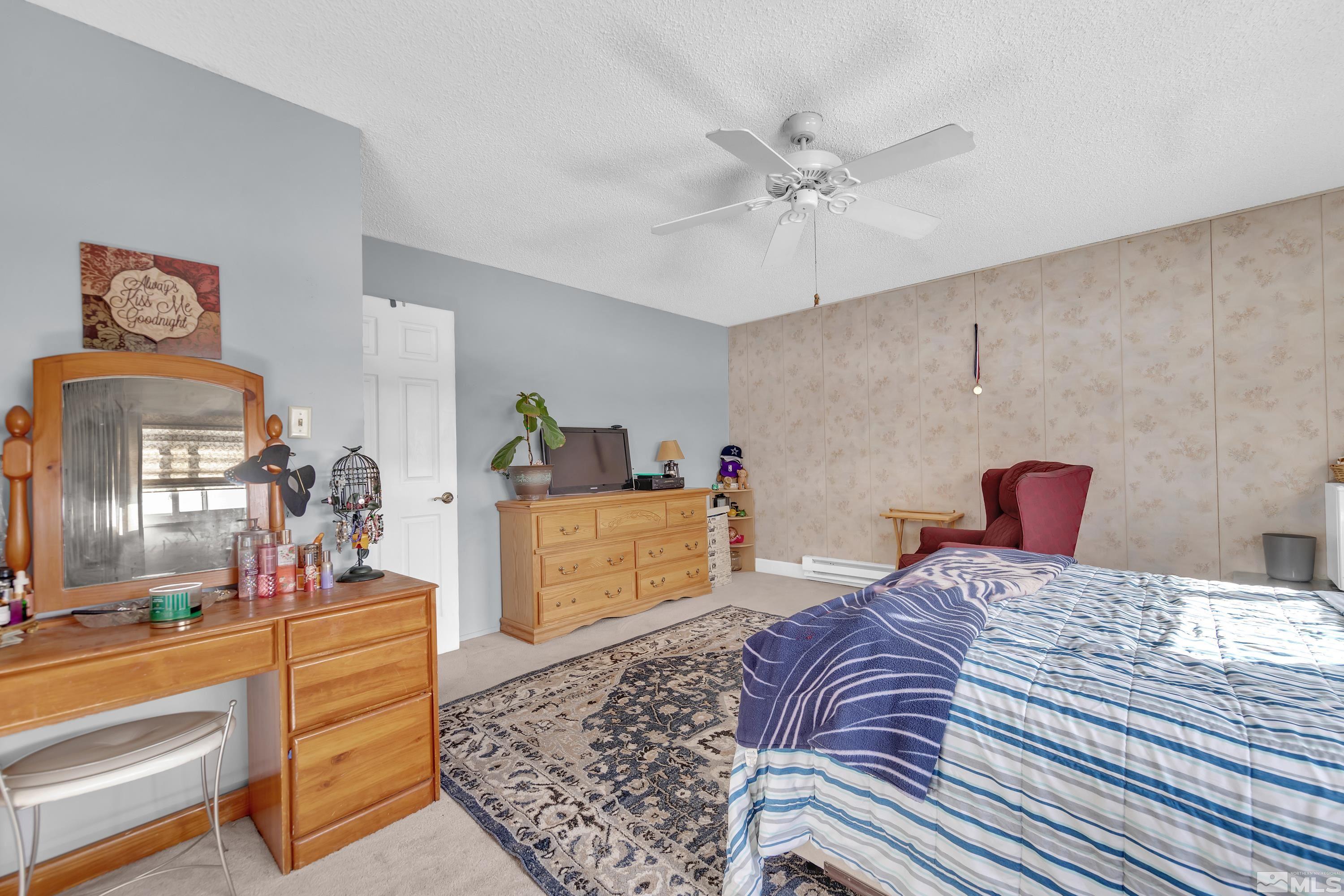 335 Smithridge Park Reno, NV 89502 - Photo 16 of 30 a bedroom with a large bed and a dresser