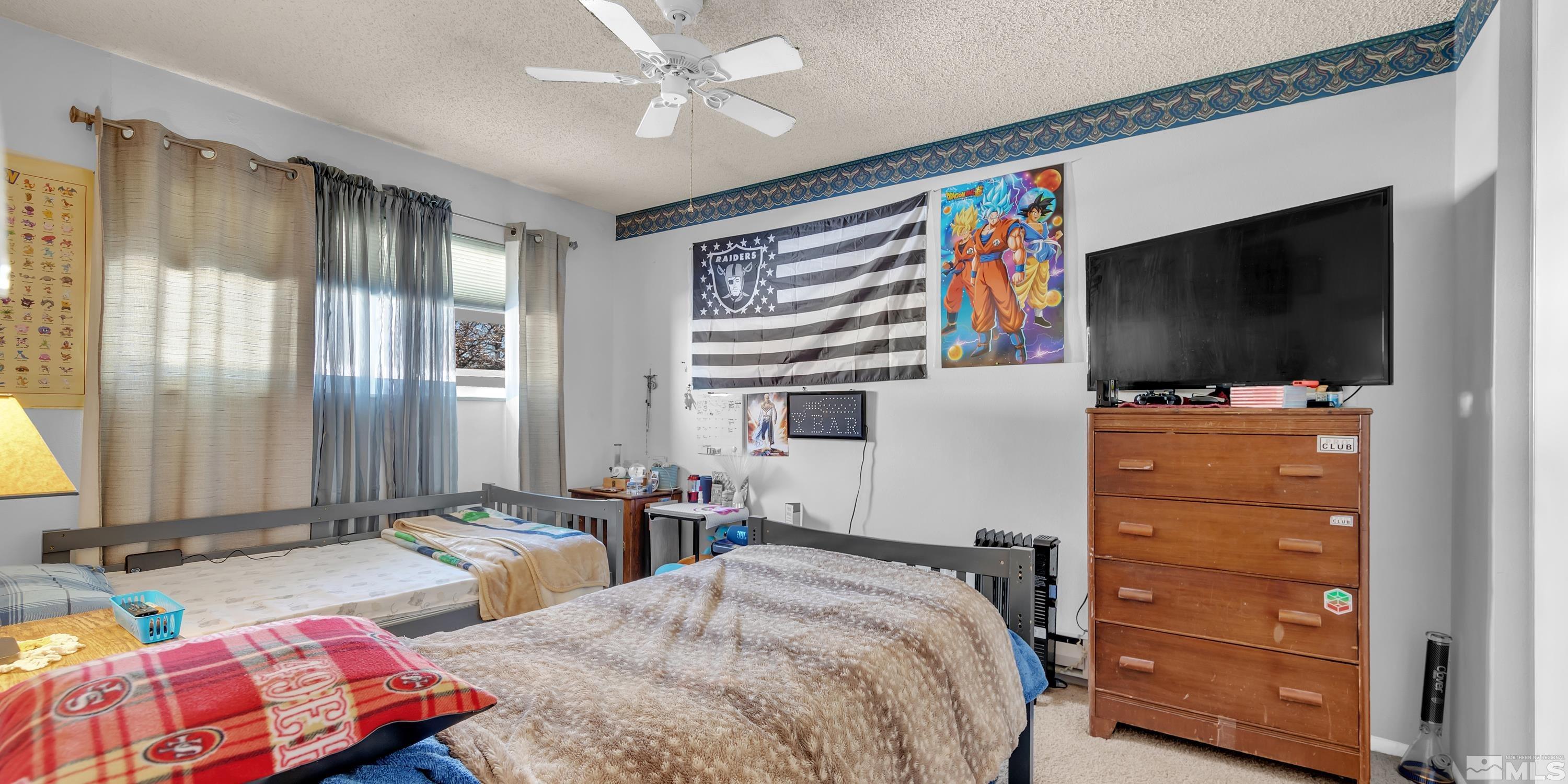 335 Smithridge Park Reno, NV 89502 - Photo 17 of 30 a bedroom with a bed and a flat screen tv