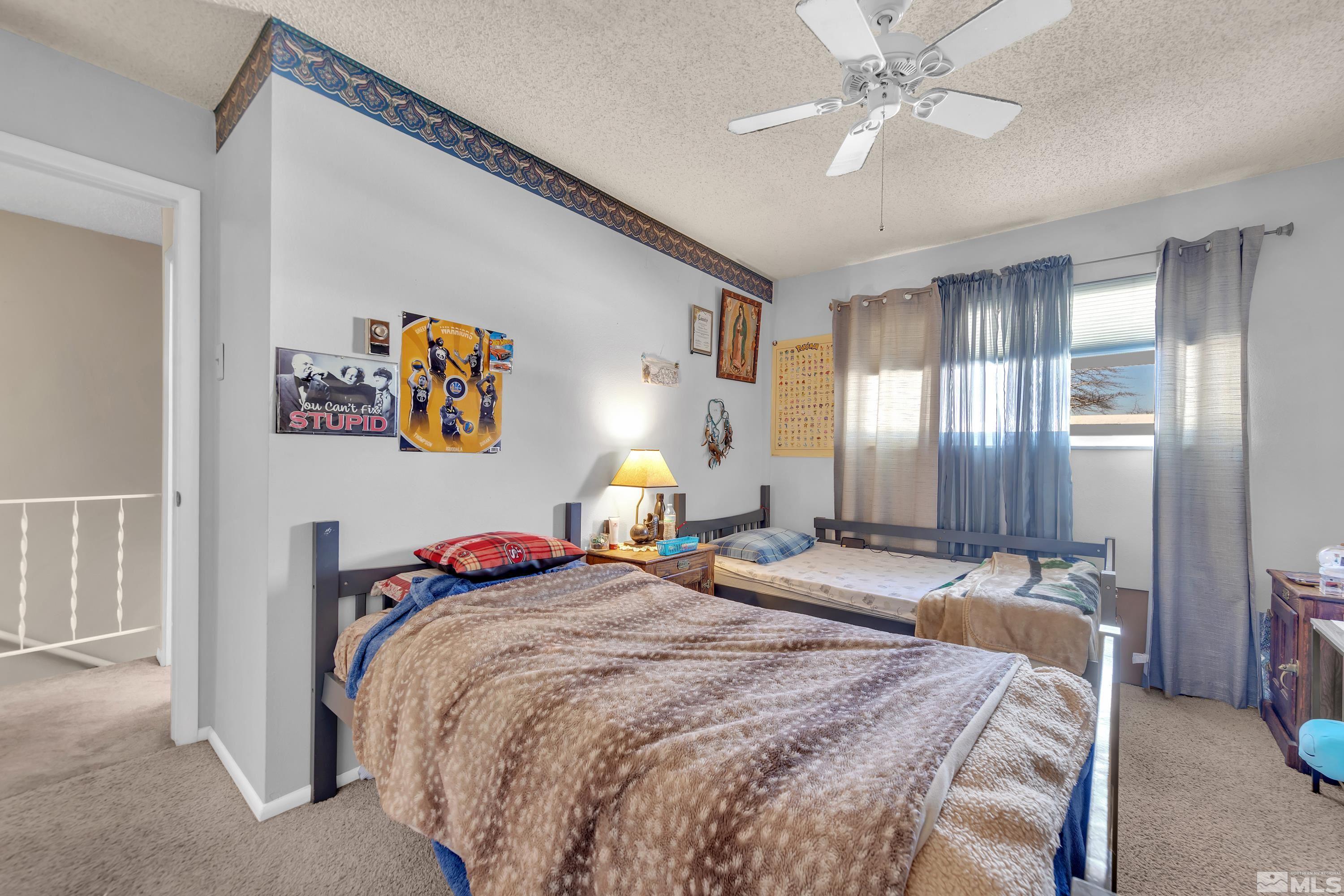 335 Smithridge Park Reno, NV 89502 - Photo 18 of 30 a bedroom with a bed and lamp