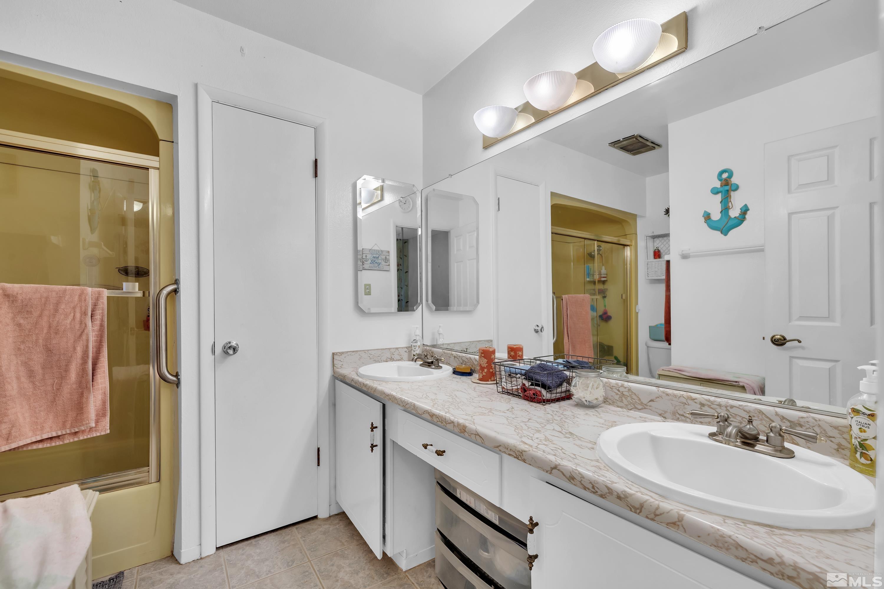 335 Smithridge Park Reno, NV 89502 - Photo 19 of 30 a bathroom with a double vanity sink and a mirror