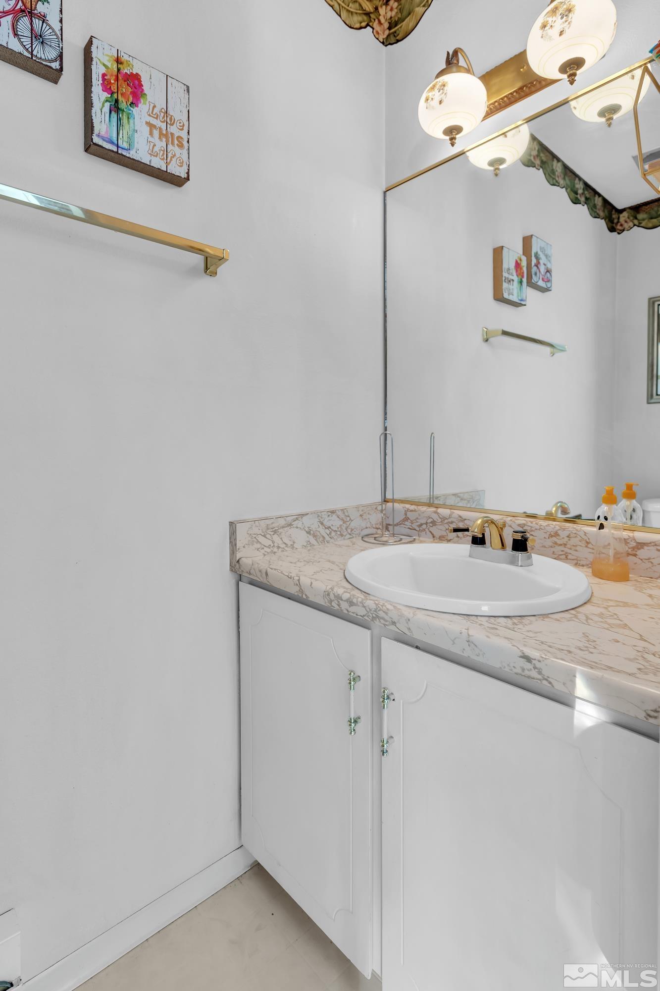 335 Smithridge Park Reno, NV 89502 - Photo 21 of 30 a bathroom with a granite countertop sink and a mirror