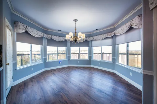a kitchen with stainless steel appliances granite countertop a stove a sink and a wooden floors