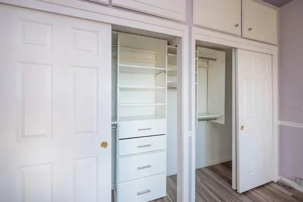 a bathroom with a granite countertop sink a toilet and shower