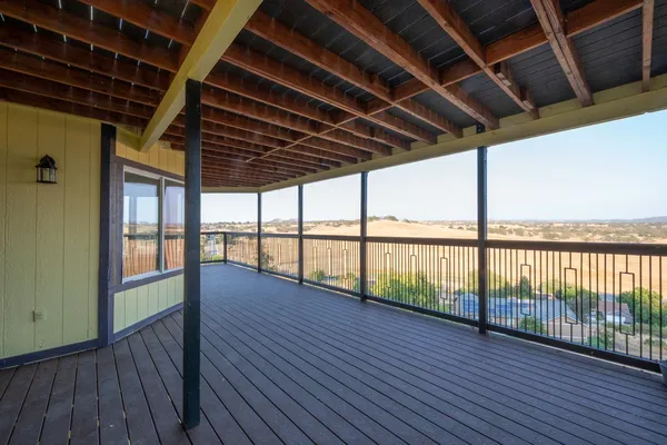 an empty room with closet and a chandelier fan