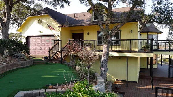 a view of a balcony with wooden floor and fence