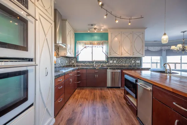 a view of a kitchen with a sink and a stove