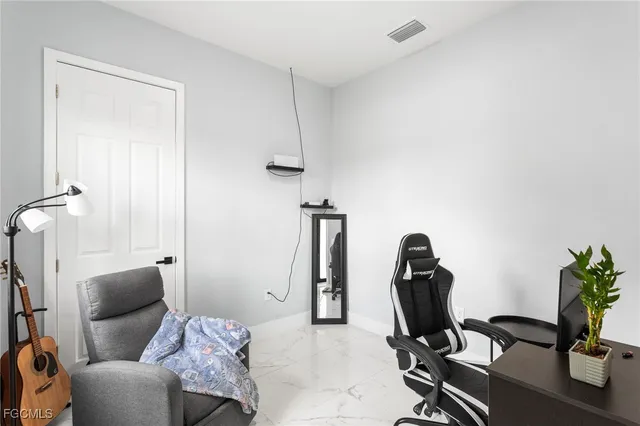a living room with furniture and ceiling fan
