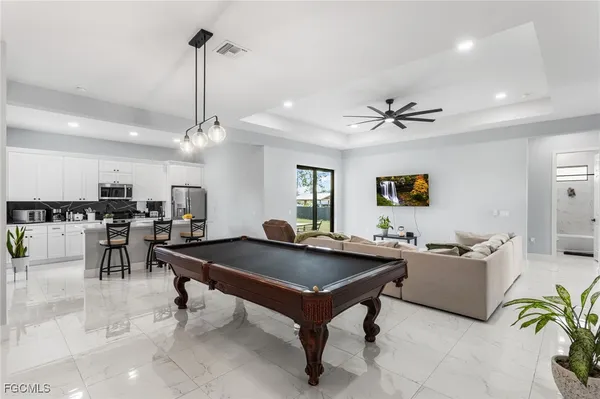 a kitchen with a sink a stove and chairs