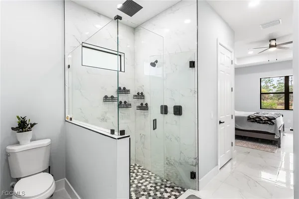a bathroom with a double vanity sink a mirror and shower